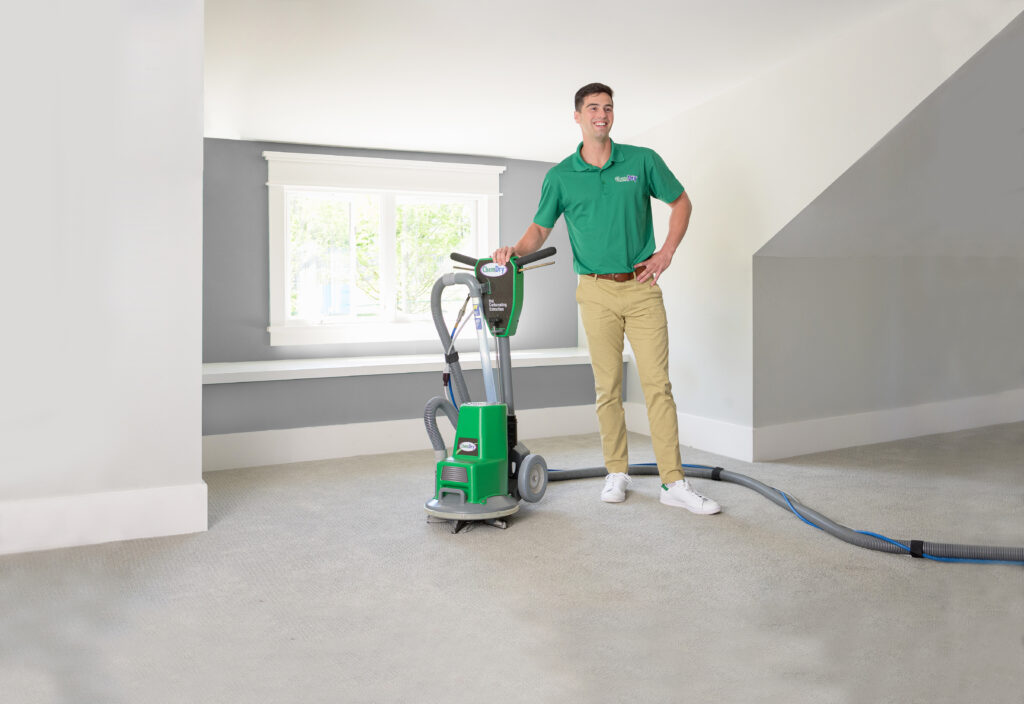 Technician cleaning carpet with Five Star Chem-Dry HCE system.